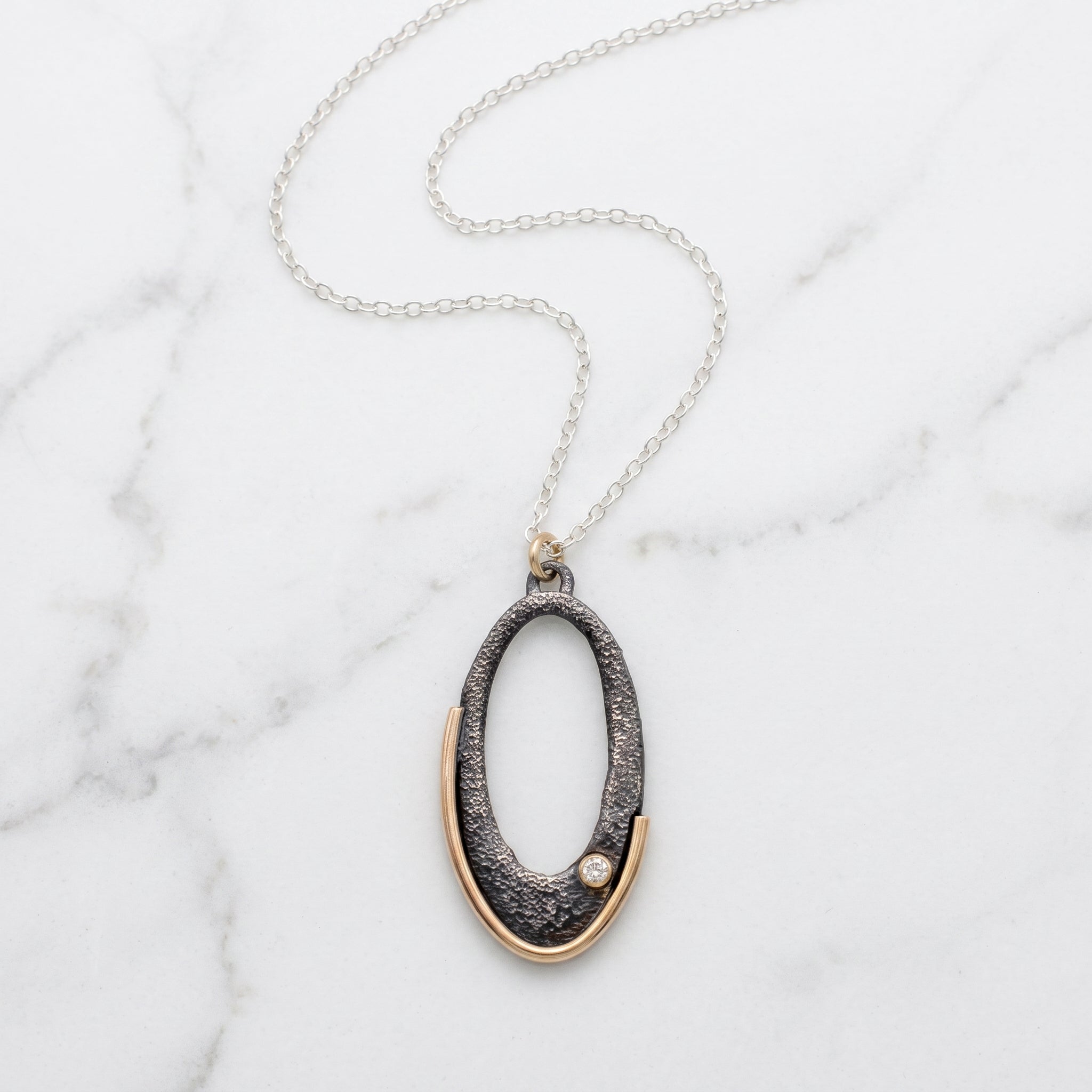 Gilded Arc Oval Pendant Necklace